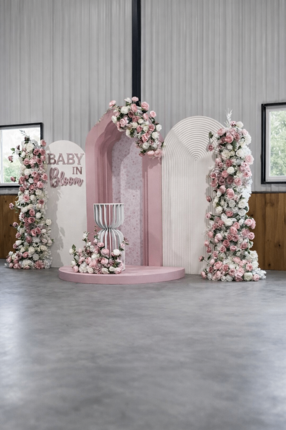 Baby in Bloom pink floral arch installation with rose pillars and pastel styling